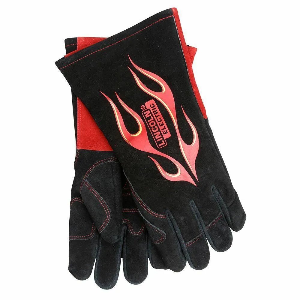 The Lincoln BLAZE MIG/STK GLOVES - KH783 are black and red flame-resistant cowhide welding gloves with flame graphics and the Lincoln Electric logo, featuring reinforced stitching and extended cuffs for extra protection.