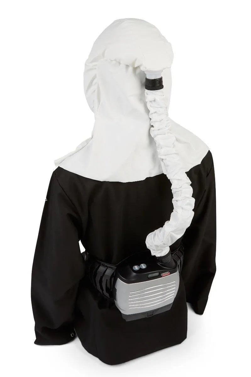 Welder in Lincoln Clear Shield HE PAPR with Standard Battery K4886-1, white hood, air hose, and waist-mounted powered respirator.