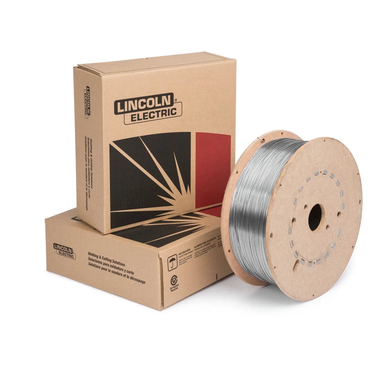 A large spool of MIG wire for carbon steel welding rests in front of two cardboard boxes labeled “Lincoln Electric,” featuring a black and red geometric design and company logo.