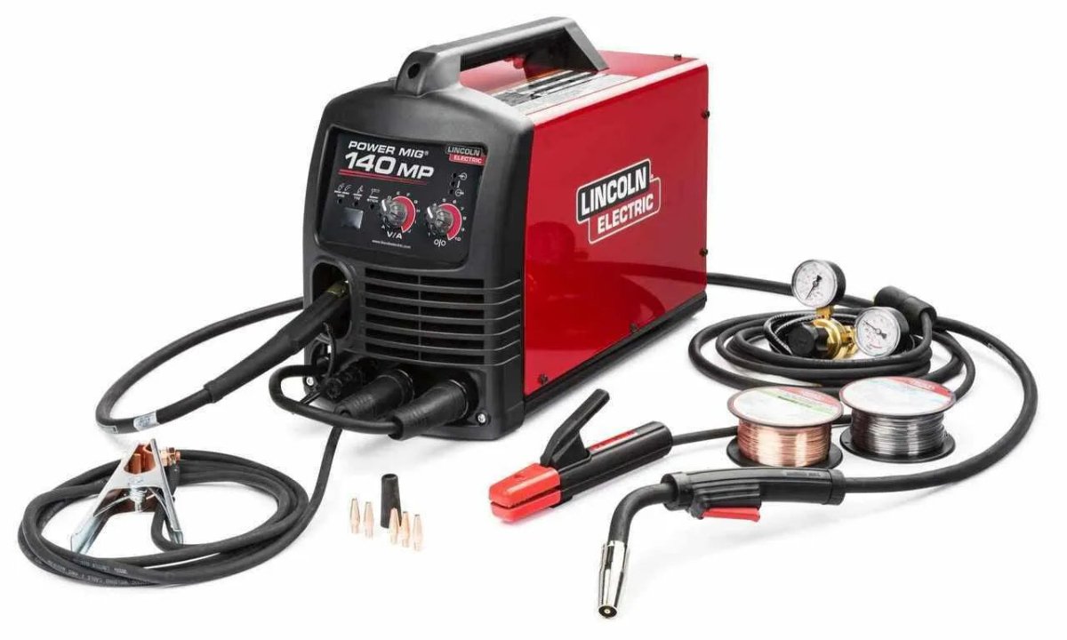 Lincoln Power MIG 140 MP Multi-Process Welder with cables, clamps, gun, pressure gauges, wire spools—premium welding equipment.