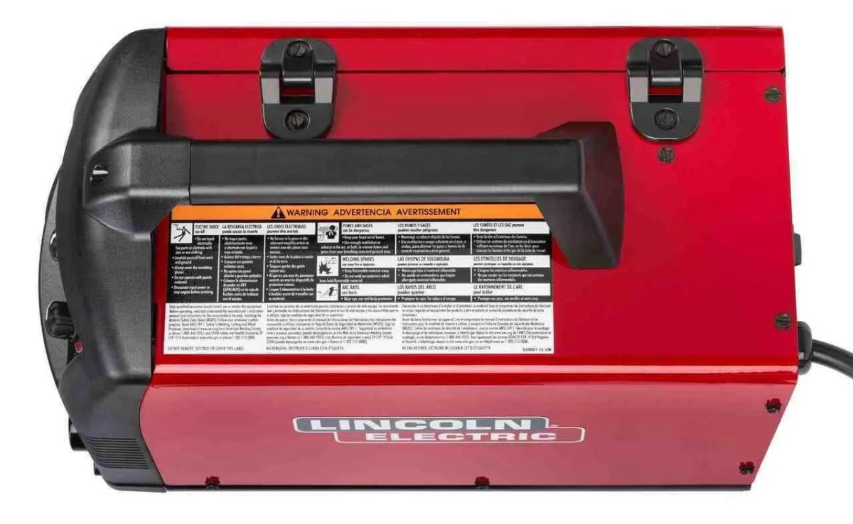 A red Lincoln Power MIG 140 MP multi-process welder is shown from the top angle, featuring a black handle, warning labels, and an attached power cord.