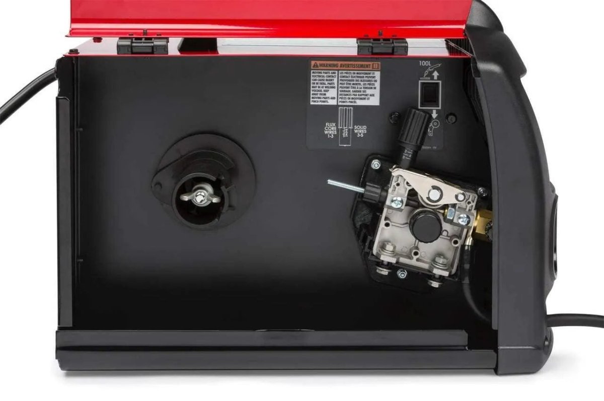 Lincoln Power MIG 140 MP Multi-Process Welder open side view showing spool holder, wire feeder, and adjustment knobs for welding equipment.