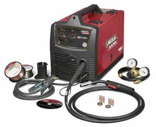 Lincoln Electric SP 140T MIG Welder Factory Demo with cables, welding gun, wire spools, gauges, and accessories on white background.