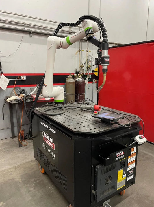 Lincoln Cooper CRX-10iA/L Aluminum Welding Cobot Cart on workstation with control panels, cables, and gas cylinders at WeldingMart.