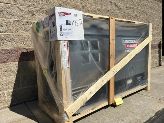 Lincoln Frontier 400X demo engine-driven welder Kubota U3484-2 in crate, wrapped for shipping, at WeldingMart, brick wall backdrop.