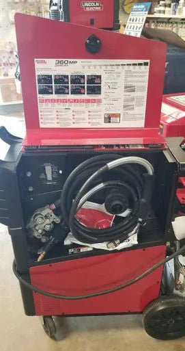 Lincoln Power MIG 360MP Multi-Process Welder U4467-1 with open panel showing settings, instructions, and welding cables inside.
