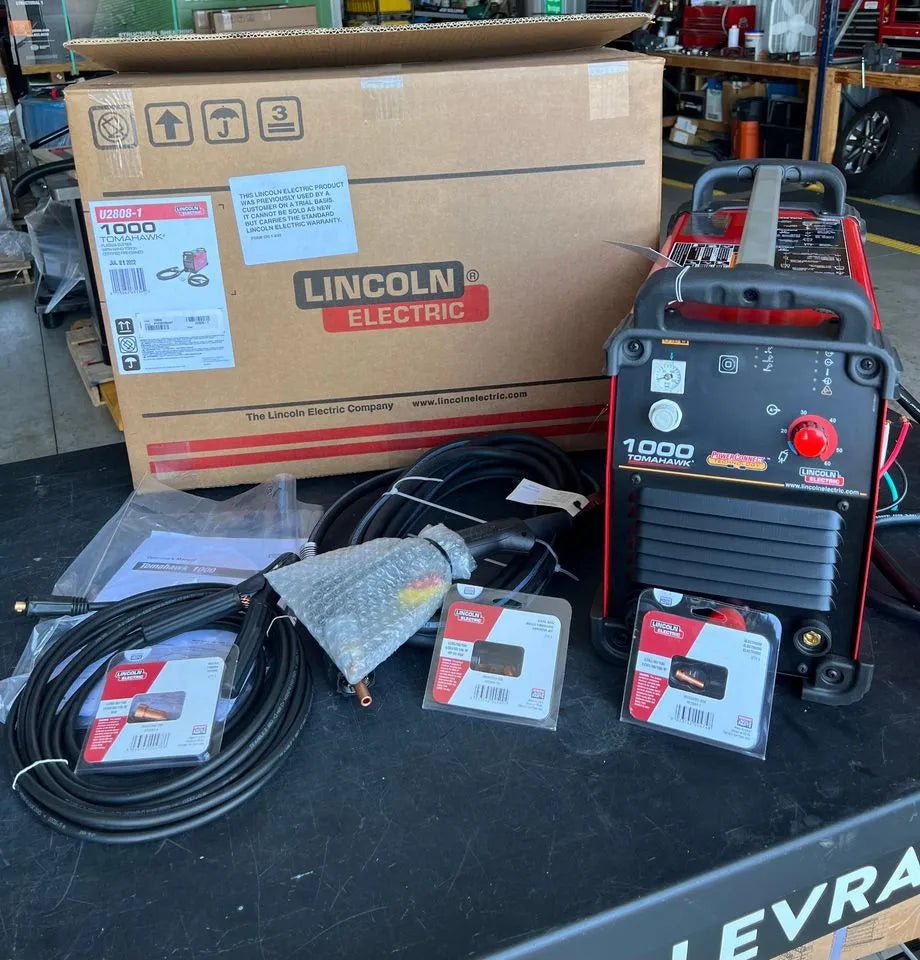 Lincoln Tomahawk 1000 Plasma Cutter with hand torch, cables, box, manuals; top welding equipment for industrial metal cutting.