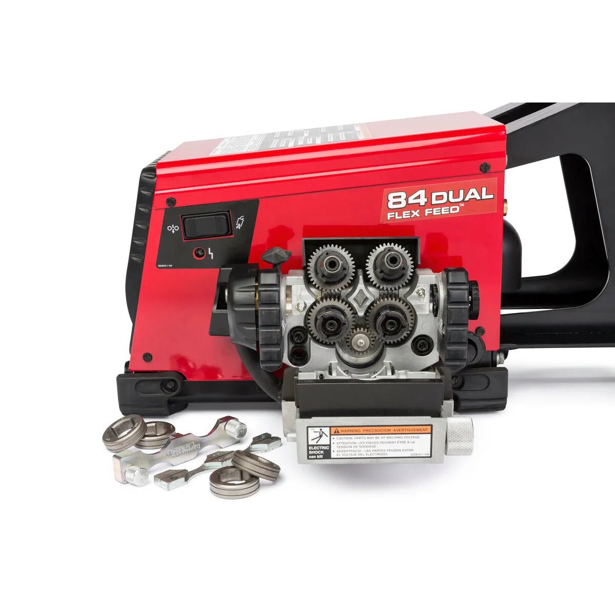 A Lincoln Flex Feed 84 Dual Bench with Heavy Duty Wire Reel Stand (K5002-5) is shown with its front panel open, displaying metal gears. Several metal parts and wrenches rest on the white surface, and the wire reel stand has a black handle.