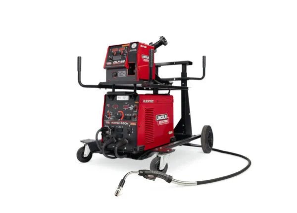 A Lincoln Flextec 350X PowerConnect / DLF-82 Ready-Pak (K5336-1) welding machine sits on a black wheeled cart with handles, a mounted wire feeder, and extra storage. A welding gun with a black hose is attached for versatile use.