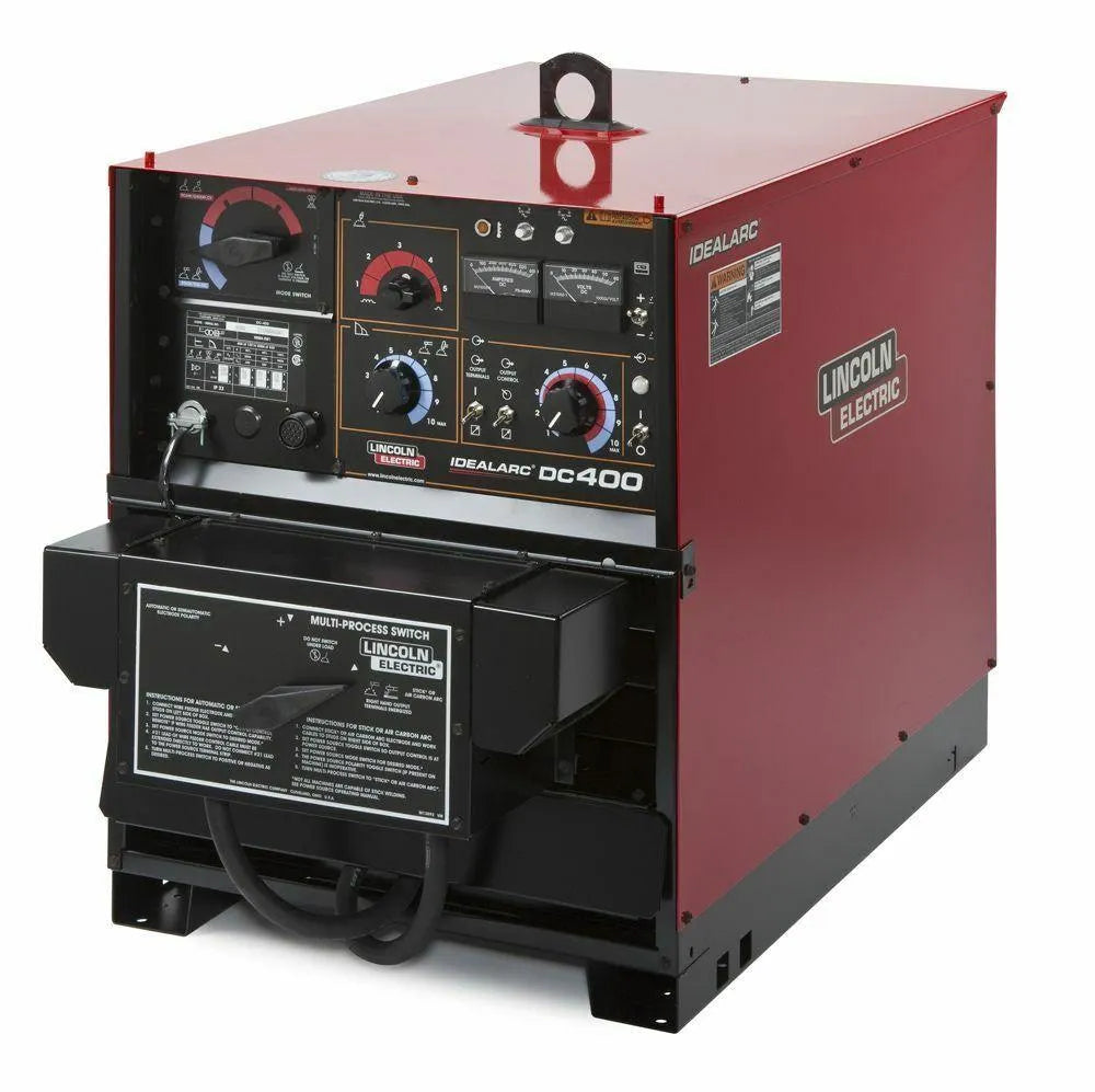 A red Lincoln IDEALARC DC-400 multi-process welder features multiple control knobs, switches, and labeled panels on the front. This industrial welding machine has a black base and includes a visible power cable.