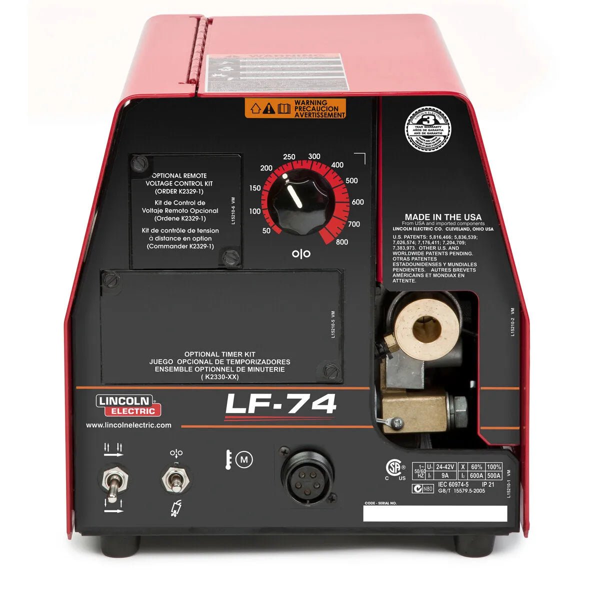 A close-up of the Lincoln LF-74 Wire Feeder, Bench Model, Heavy Duty K2426-5 shows its red and black design, control panel with a central dial, connectors, warning label, spool compartment, visible text labels, and brand logo on the front.