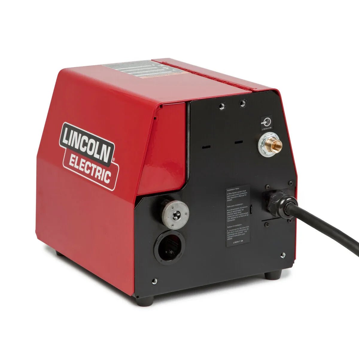 A Lincoln LF-74 Wire Feeder, Bench Model, Heavy Duty K2426-5 in red and black sits on a white background. The front panel features dials, ports, and connectors, with the brand logo on the side and a thick power cord extending from the back.