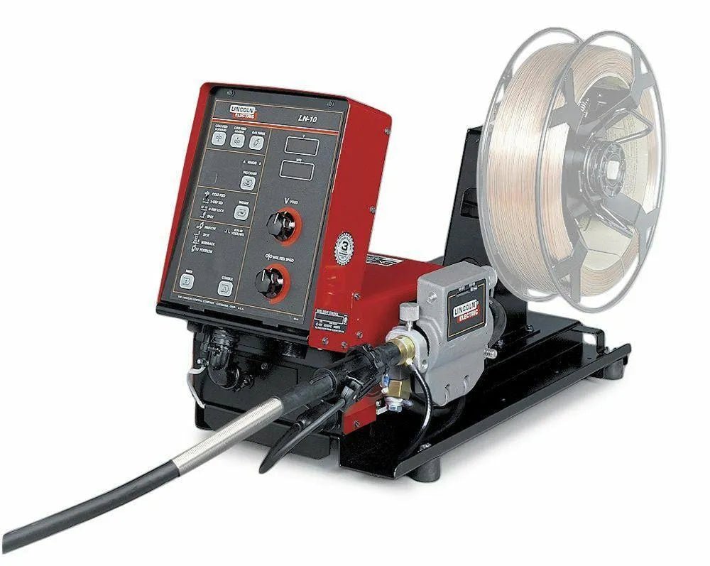 A red and black Lincoln LN-10 BENCH MODEL K1559-3 wire feeder, discontinued (see K5000-2), sits on a black base with control knobs, buttons, display panel, spool of welding wire, and a welding gun cable attached at the front.