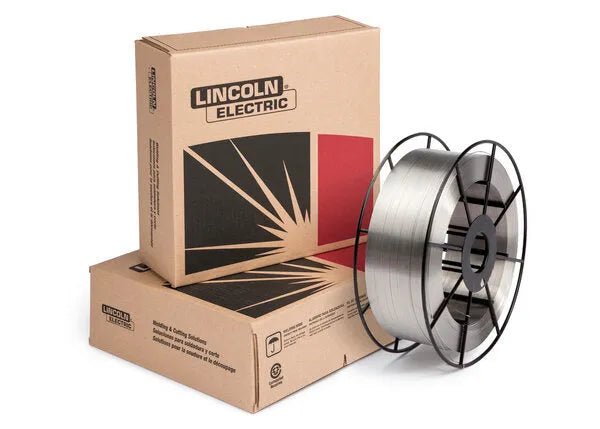 A spool of Techalloy 55 MIG welding wire sits beside two stacked cardboard boxes labeled Lincoln Electric, featuring a graphic design with black and red accents—ideal for cast iron welding projects.