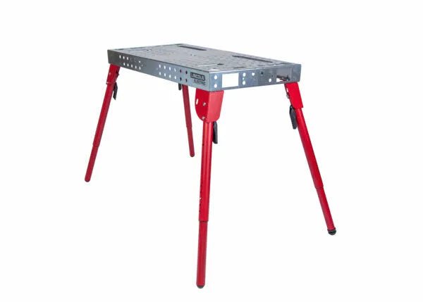 The Lincoln Portable Welding Table and Workbench K5334-1 features a gray rectangular top with holes and cutouts, four angled red adjustable legs secured by black clamps, offering sturdy support and versatile use for welding or projects.