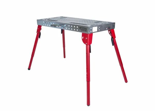 The Lincoln Portable Welding Table and Workbench K5334-1 features a rectangular perforated silver top, four red adjustable legs with black locks, and a side handle for easy transport—ideal for mobile welding jobs.