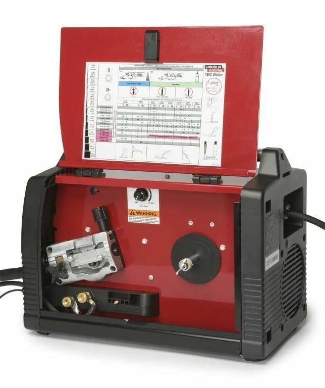 Lincoln Power MIG 180C Welder K2473-2 with open red top, wire feed, control knobs, and welding settings chart visible inside.