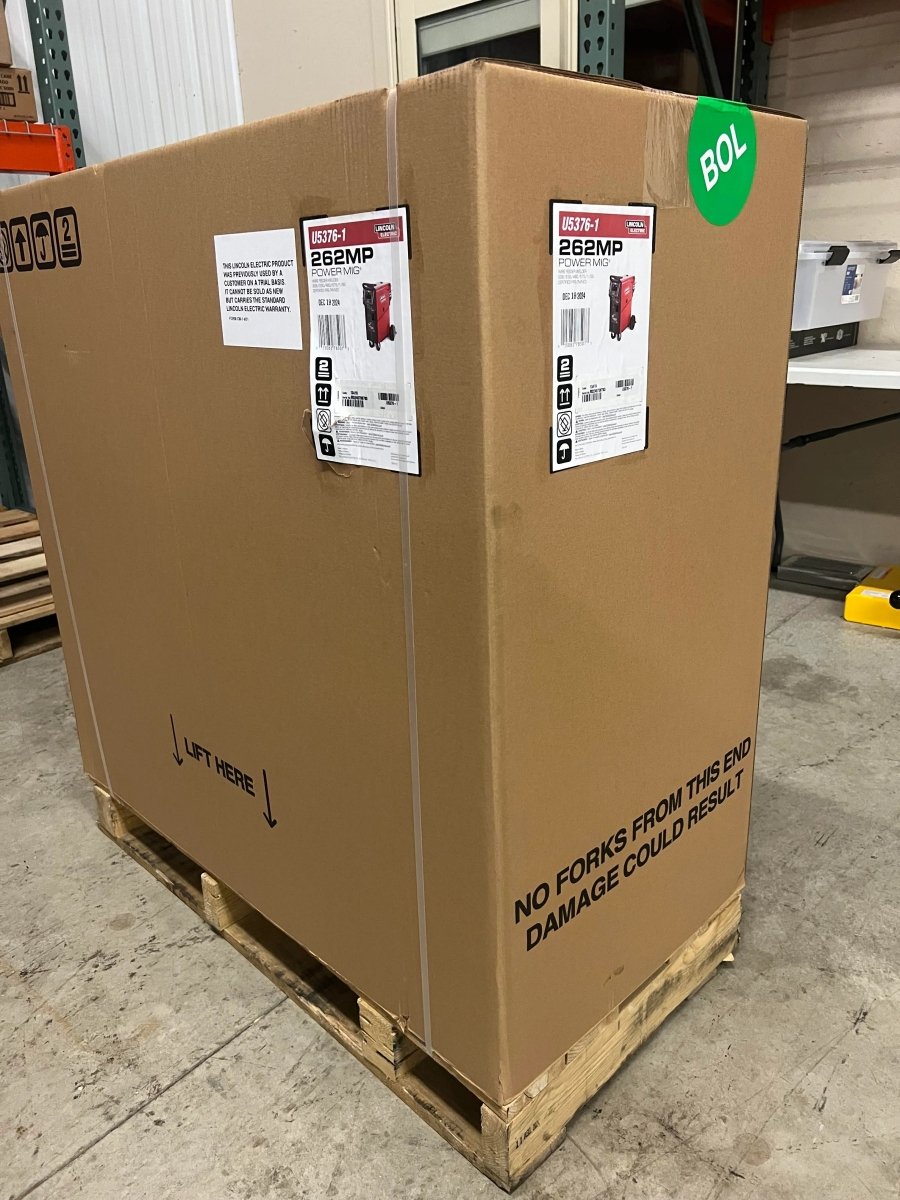 Lincoln Power MIG 262MP Multi-Process Welder in labeled box on pallet, ideal for aluminum welding, at WeldingMart warehouse.