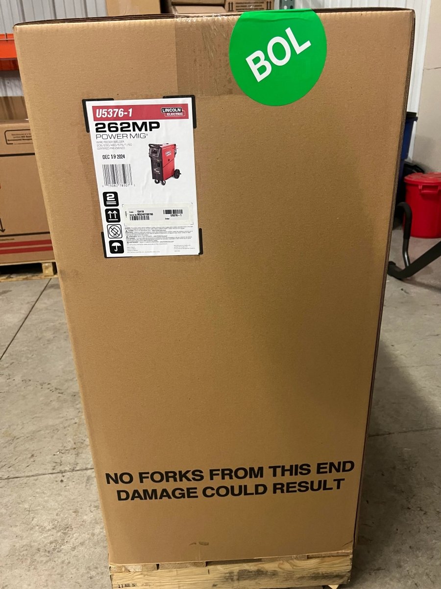 Lincoln Power MIG 262MP Multi-Process Welder in a labeled box on pallet, shipped by WeldingMart, ready for welding professionals.