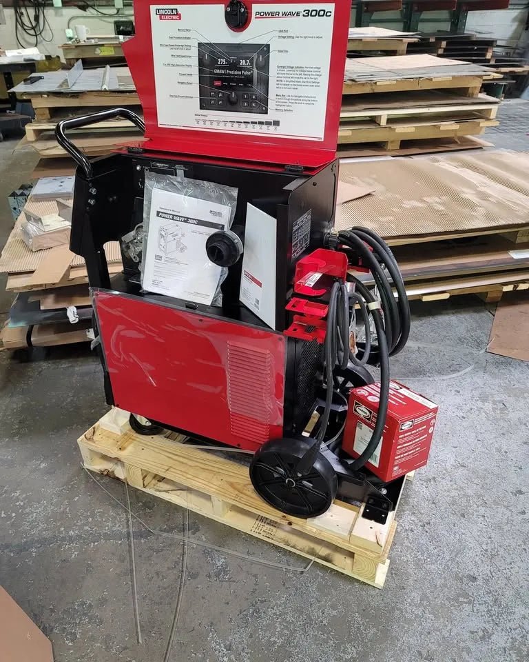 Lincoln Power Wave 300C Advanced Process Welder U4488-1 with cables and accessories on pallet in workshop at WeldingMart.