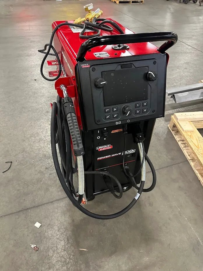 Lincoln Power Wave 300C Advanced Process Welder U4488-1 with hoses and cables on workshop floor, ideal welding equipment for pros.