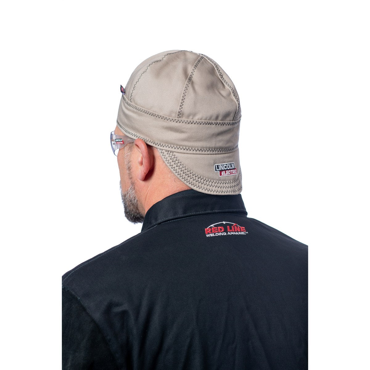Lincoln Premium FR Welding Cap in khaki with red paisley liner - worn by a welder