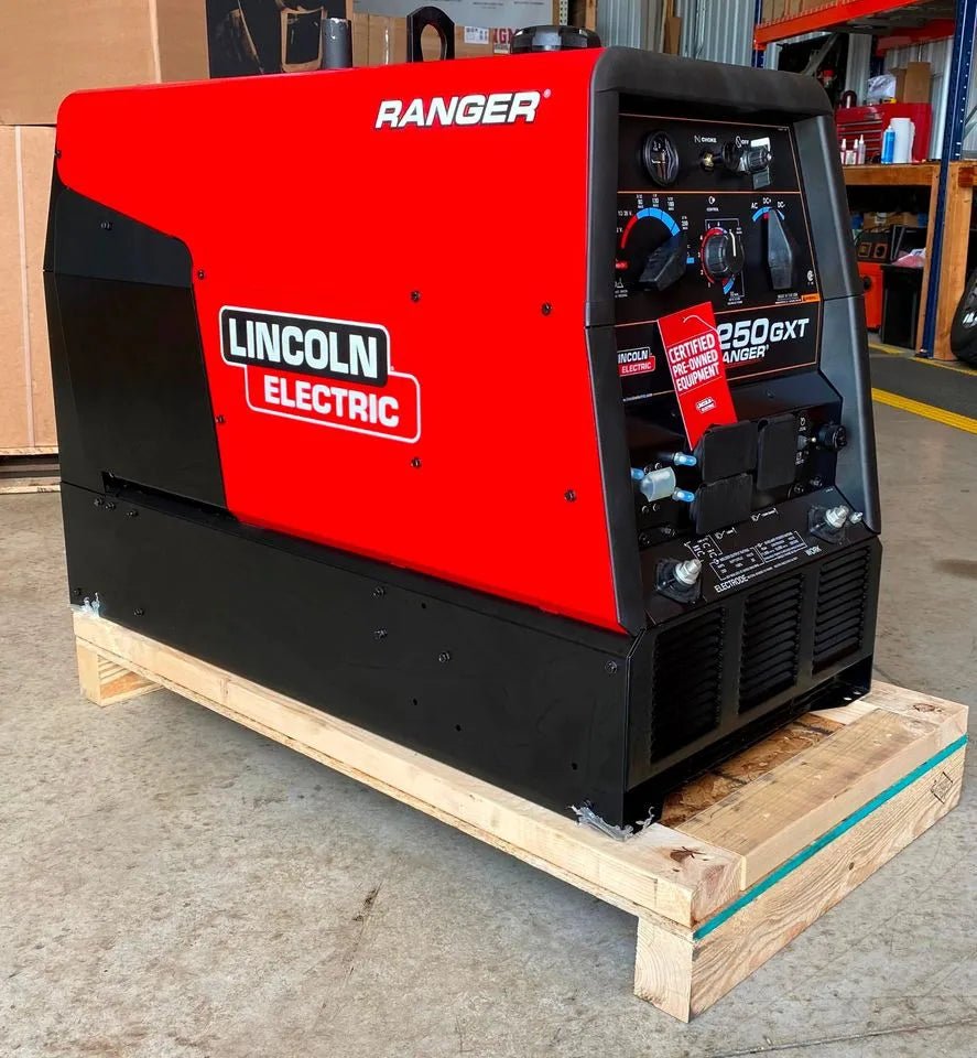 Lincoln Ranger 250 GXT welder Kohler W/EFP, red/black, on pallet in warehouse. Welding controls and gauges visible. WeldingMart.