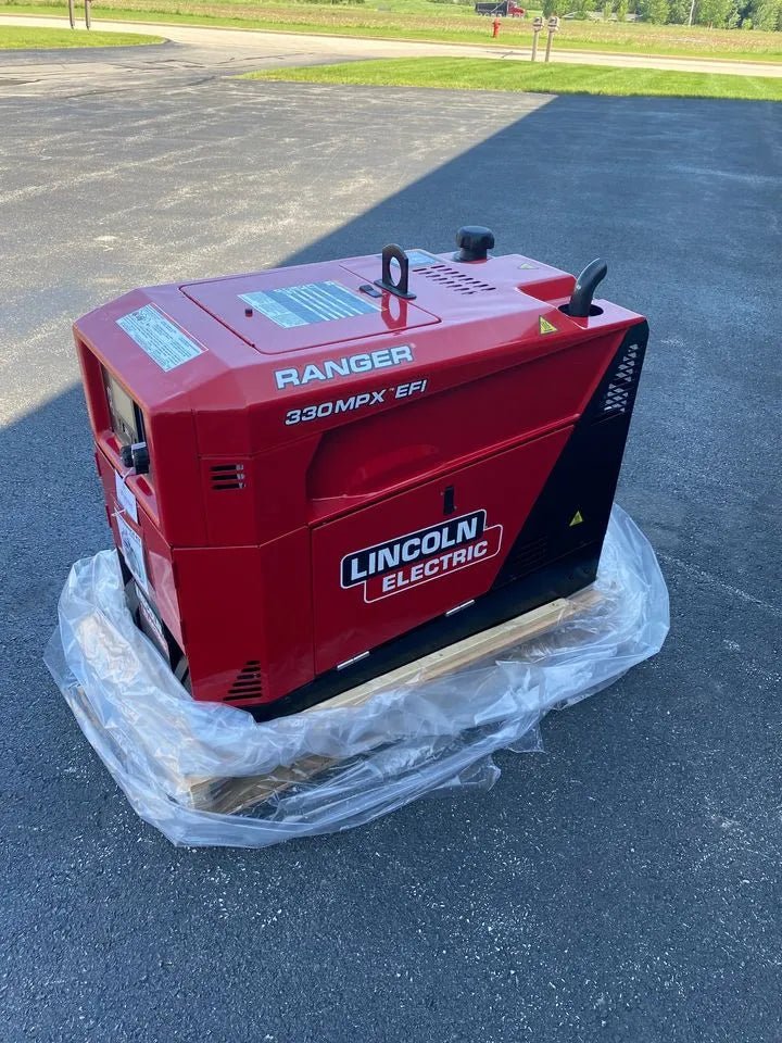 Lincoln Ranger 330MPX EFI engine-driven welder generator, red, low hour, on pallet outdoors. WeldingMart welding equipment.