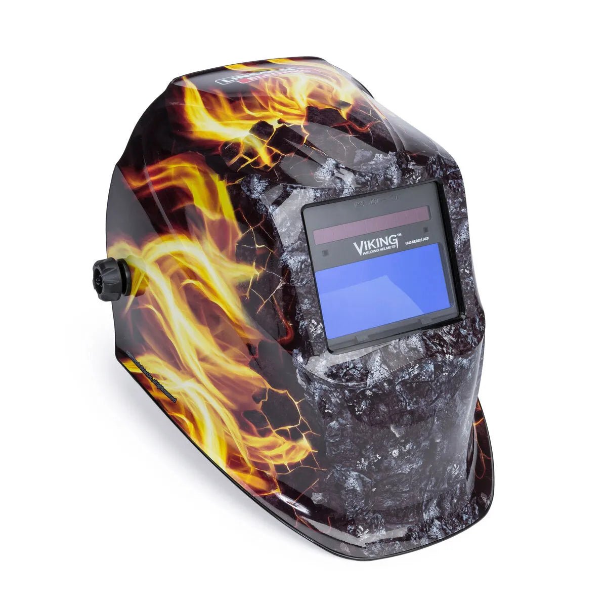The Lincoln VIKING 1740 Ignition Welding Helmet - K4375-3 features bold fiery flames on a dark surface, a rectangular viewing window with 4C Lens Technology, and an adjustment knob for advanced auto-darkening control.