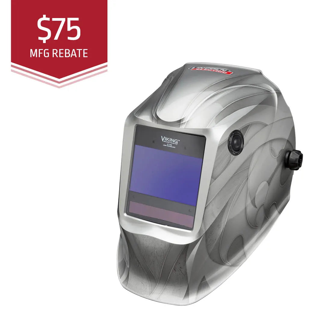 A silver Lincoln VIKING 2450 Heavy Metal Welding Helmet - K3029-4 with 4C Lens Technology features an auto-darkening lens and stylish swirling patterns. A red label in the top left shows $75 MFG REBATE in white with decorative lines underneath.