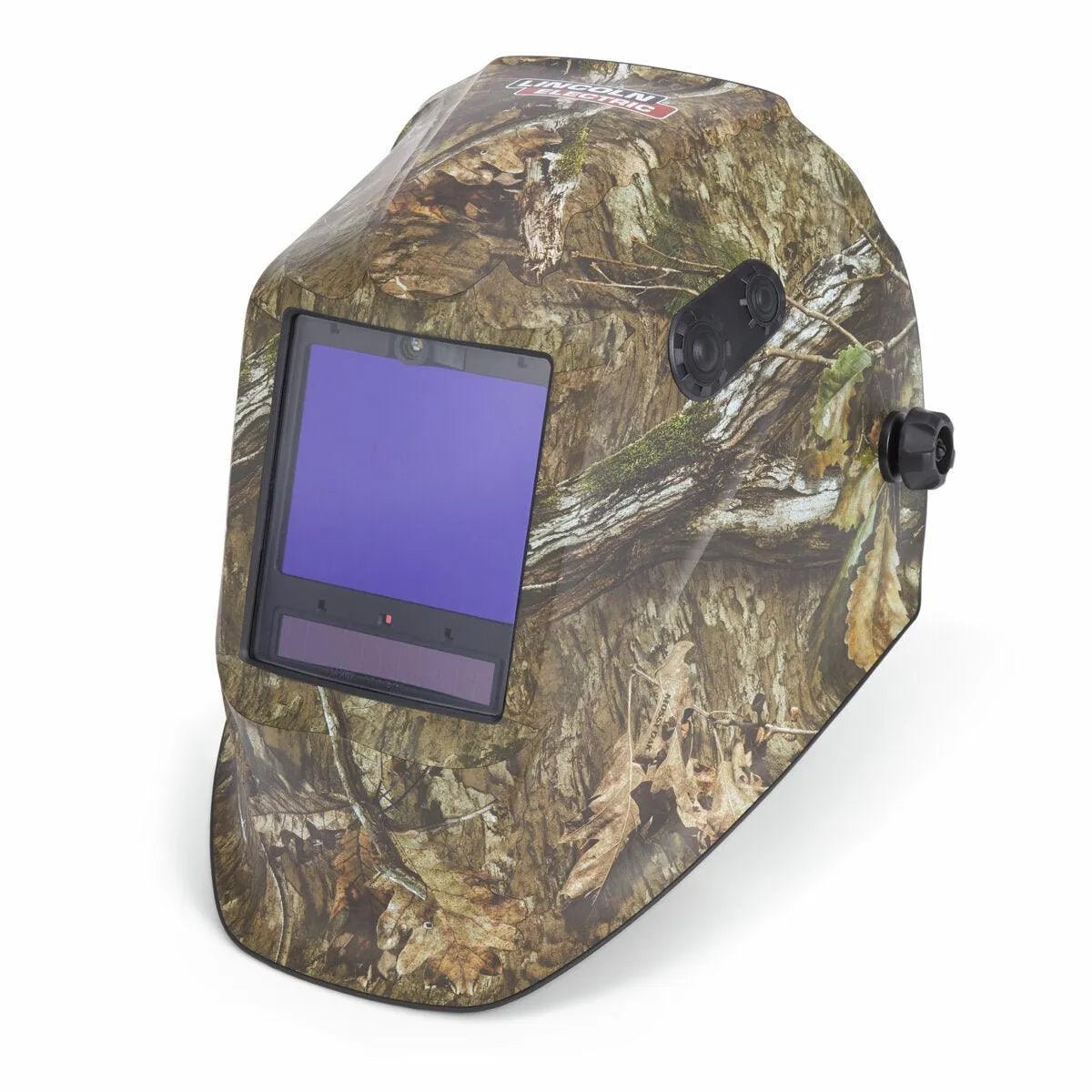 The Lincoln VIKING 3350 ADV Mossy Oak Country DNA Welding Helmet (K5423-5) features a brown and green camouflage pattern, tree bark and leaf accents, an auto-darkening rectangular lens, and a side adjustment knob.