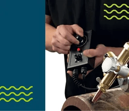 A worker adjusts a Mathey E-Z Pipecut Tip 1 Flame Cutter (EZPCTP1) on a metal pipe, WeldingMart welding equipment in use.