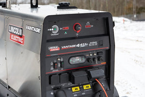 Lincoln Vantage 441X Engine Driven Welder Perkins (U4535-1) on snow with control panels, gauges, and power cords attached.
