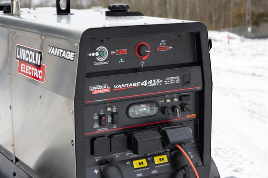 Lincoln Vantage 441X Engine Driven Welder Perkins (U4535-1) on snow with control panels, gauges, and power cords attached.