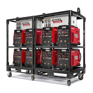 Two black metal carts fitted with Lincoln Caster Kit K2665-1 hold eight red and black Lincoln Electric Flextec welding machines. Each wheeled cart displays the Lincoln Electric logo and sits side by side against a white background.