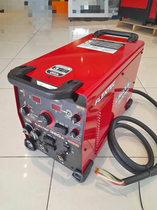 Lincoln Flextec 350X Power Connect U4273-1 welding machine, red, with controls, connectors, and cable on tiled floor.