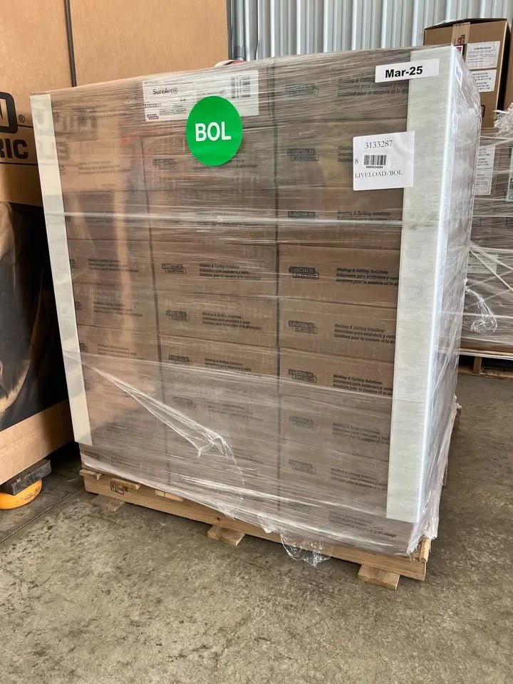 Lincoln ED030613 SureArc S6 .045 MIG Wire pallet (81 rolls), wrapped in plastic for welding tools, WeldingMart shipping label visible.
