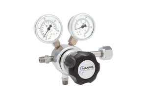 The Harris 701-125-540-C Oxygen Regulator is a single-stage unit with two gauges (psi/kPa), stainless steel diaphragm, metal fittings, and a black adjustment knob labeled Harris Specialty Gas.