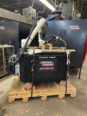 Lincoln Cooper CRX-10iA/L Welding Cobot Cart (AD2489-14) on pallet in workshop with cabinets, tools, and welding equipment.