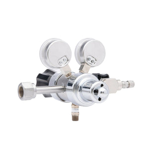 A close-up of the Harris HP702-050-320-BE Carbon Dioxide Regulator shows two pressure gauges, adjustment knobs, and multiple connectors, all set against a white background.