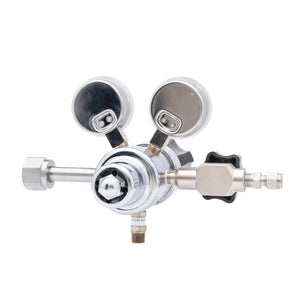 The Harris HP702-050-320-BE Carbon Dioxide Regulator features two round gauges, an adjustment knob, and multiple ports. Photographed on a white background, this high purity CO2 regulator ensures precise control for laboratory use.