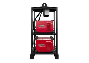 A black metal welding rack (Lincoln Flextec 350X PowerConnect 6-Pack Rack - K4727-2) holds two red Flextec 350X machines, each on separate shelves. A top hook allows lifting, and cables are coiled beside each unit. Background is plain white.
