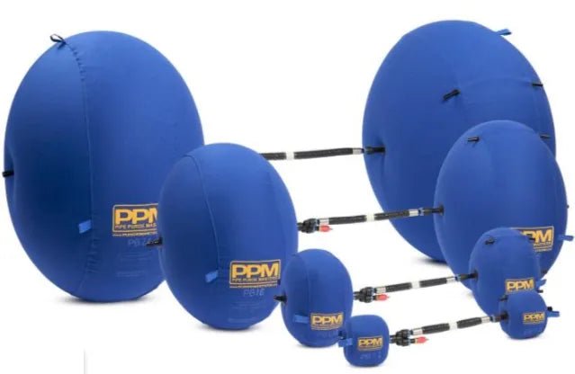 The Mathey Dearman Inflatable Double Purge Bag System 58-84mm 3 - PB03 features seven blue pipe plugs with yellow PPM logos, connected by black hoses and valves, arranged in two rows on a white background—ideal for pipeline welding.