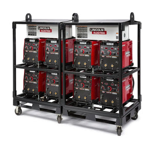 Two black inverter racks on wheels, each equipped with a Lincoln Caster Kit K2665-1, hold four red Lincoln Electric welding machines side by side on a white background, highlighting storage and mobility for industrial equipment.