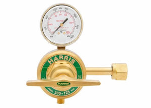 A Harris 330 high pressure oxygen regulator with a brass body and a pressure gauge on top, marked HARRIS in green. The gauge displays readings in psi and kPa, while the control knob and threaded connector are on the right side.