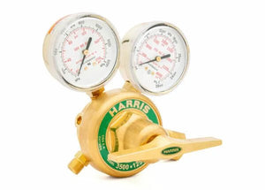 A brass Harris High-Pressure Oxygen Regulator with two gauges and a green label, designed for controlling and monitoring gas flow in high-flow cylinder applications. The front gauge shows delivery pressure; the top displays tank pressure.