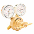 A brass single stage regulator with two pressure gauges labeled “Harris,” used to measure and regulate gas pressure, featuring clear dials and a large adjustment handle at the bottom.