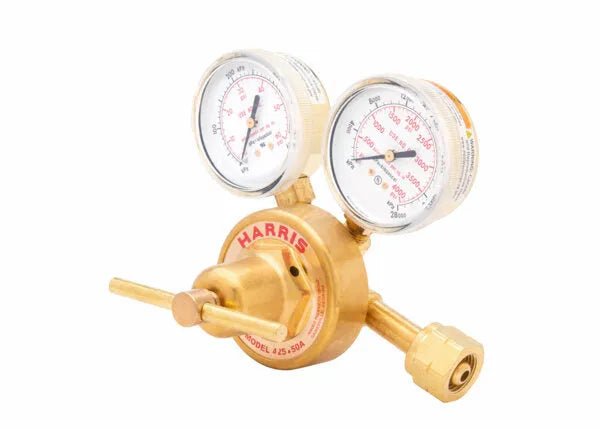 A brass single stage regulator with two analog gauges and a control knob. The gauges display pressure readings, and the device is labeled HARRIS. This industrial gas regulator is used for controlling gas flow.