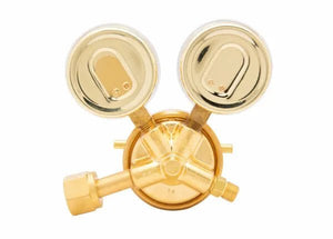 A brass industrial oxygen regulator with two round pressure gauges on top is displayed against a white background.