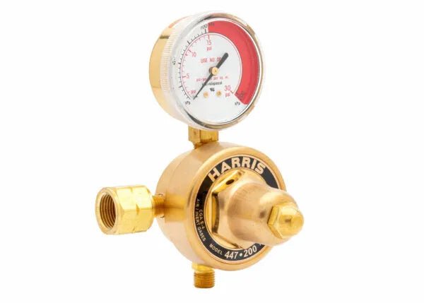 Harris 447-50-CRM single stage brass regulator for welding, features gauge, threaded connectors, and HARRIS branding.